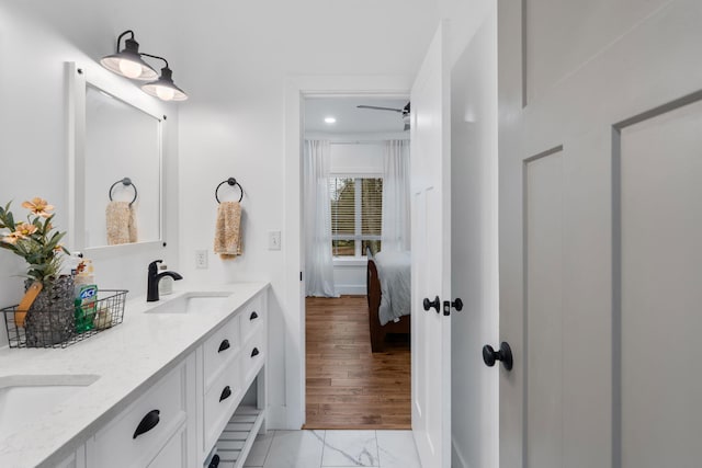 bathroom with double vanity, marble finish floor, ensuite bath, and a sink