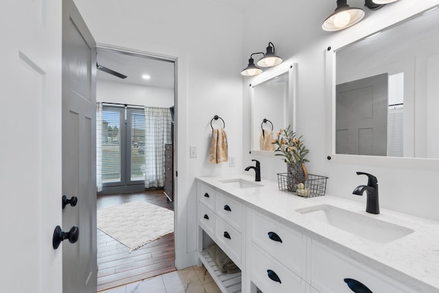 bathroom featuring a sink and double vanity