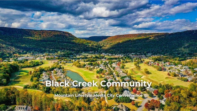 bird's eye view with a mountain view and golf course view