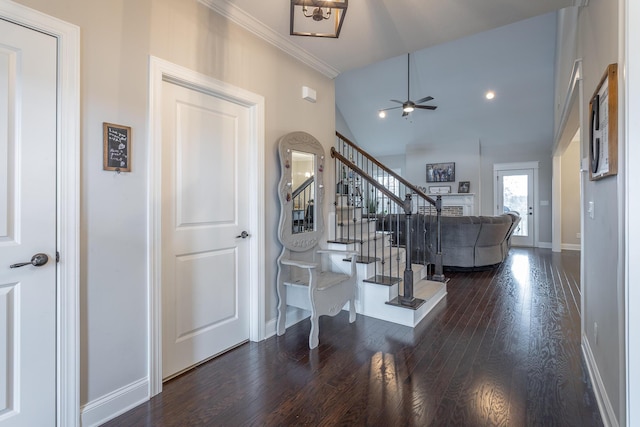 entrance foyer featuring wood finished floors, a ceiling fan, baseboards, stairs, and vaulted ceiling