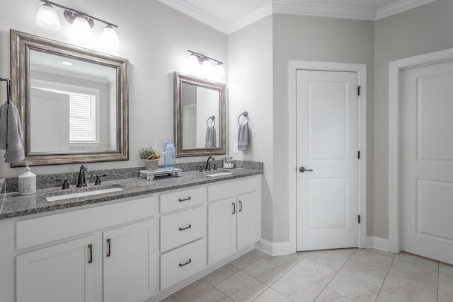 bathroom featuring double vanity, crown molding, a sink, and tile patterned floors