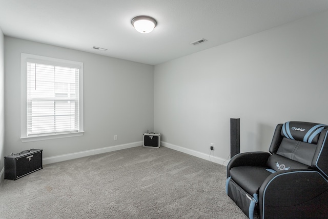 sitting room with carpet, visible vents, and baseboards