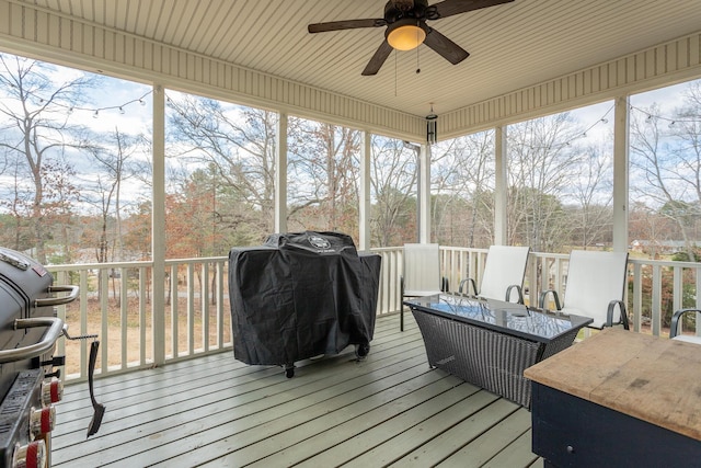 sunroom / solarium featuring a ceiling fan and a healthy amount of sunlight