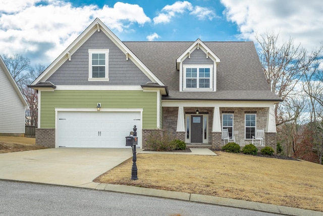 craftsman inspired home with brick siding, covered porch, concrete driveway, a front yard, and stone siding