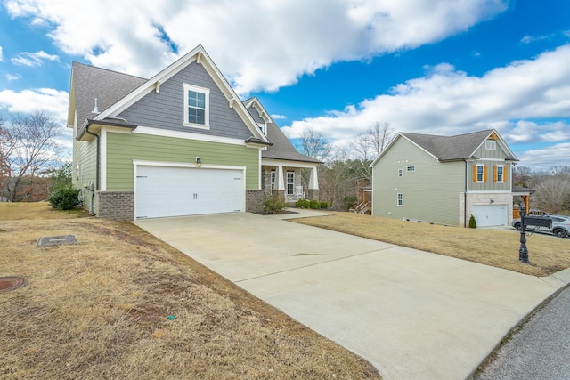 view of front facade with brick siding, roof with shingles, concrete driveway, covered porch, and a front yard