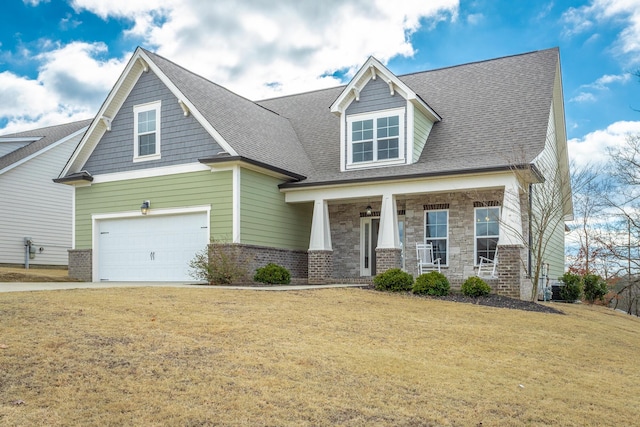 craftsman inspired home featuring a porch, stone siding, a front lawn, and a garage