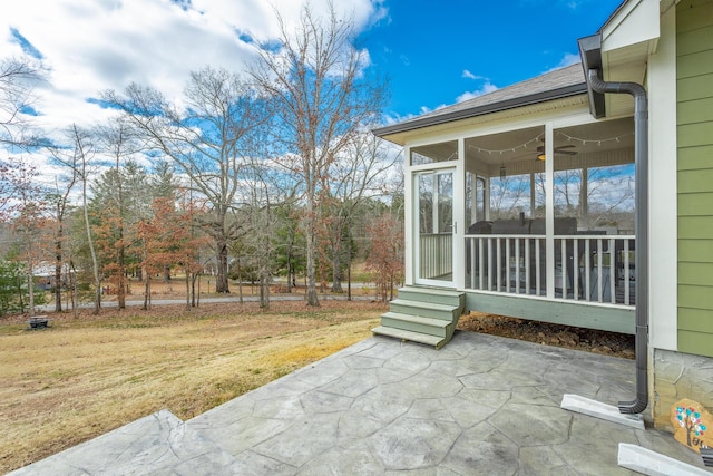 view of patio / terrace with a sunroom and a ceiling fan