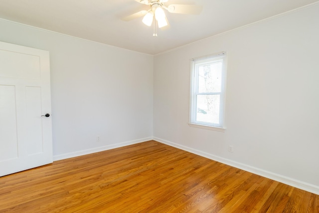 unfurnished room with ornamental molding, baseboards, light wood finished floors, and a ceiling fan