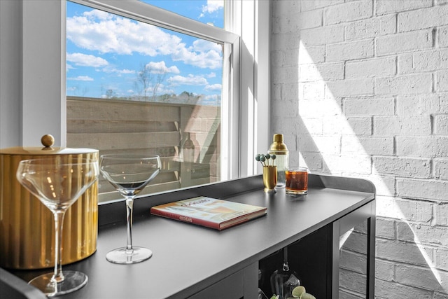 office space featuring wine cooler and concrete block wall