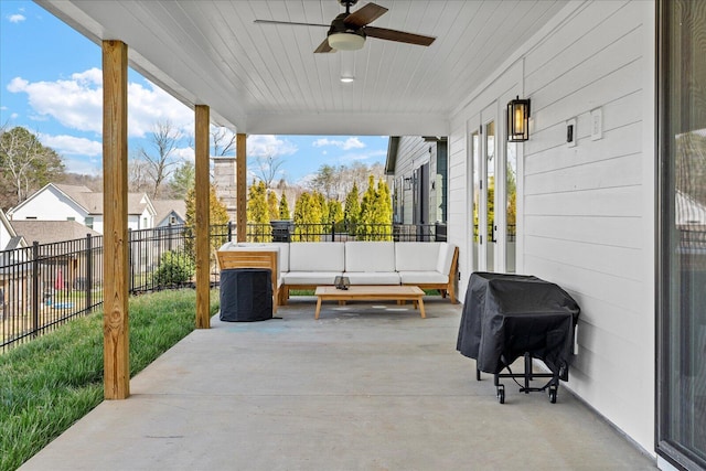 view of patio with an outdoor living space, area for grilling, fence, and ceiling fan