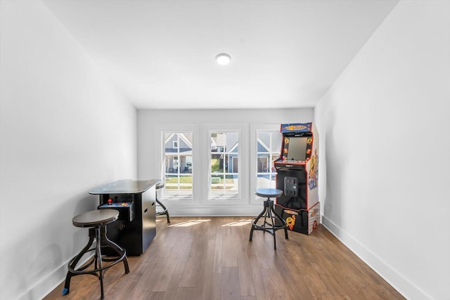 interior space featuring baseboards and wood finished floors