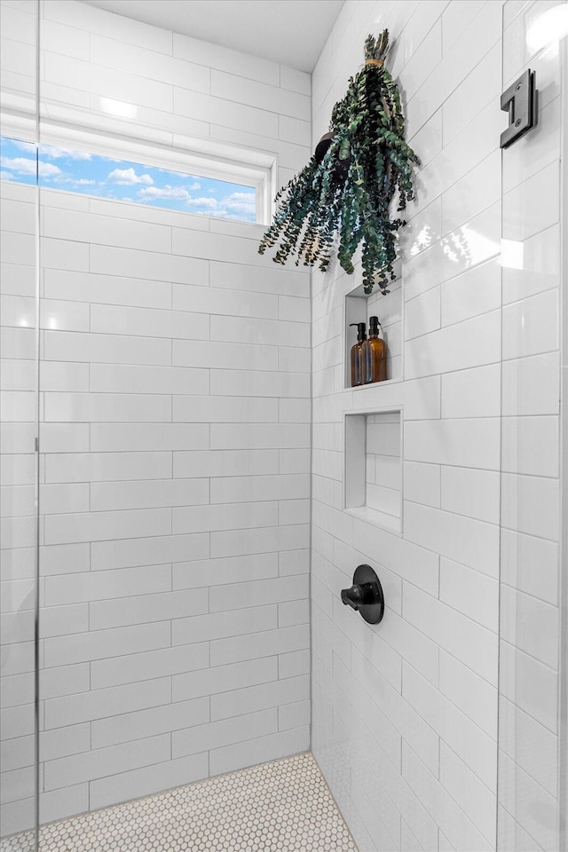 bathroom with a tile shower