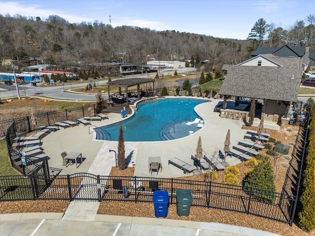 view of pool with a grill, a pergola, and fence