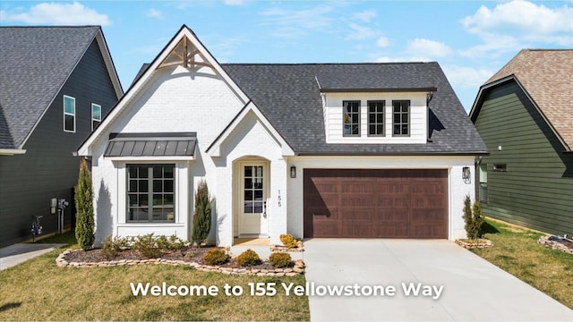 view of front of property featuring driveway, a shingled roof, a garage, brick siding, and metal roof