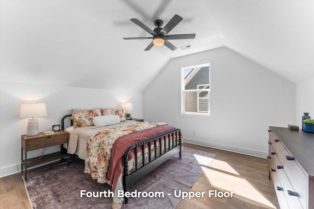 bedroom featuring visible vents, wood finished floors, baseboards, lofted ceiling, and ceiling fan