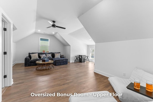 living area with lofted ceiling, wood finished floors, baseboards, and ceiling fan