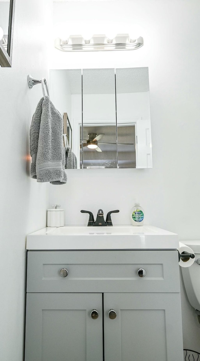 bathroom featuring toilet and vanity