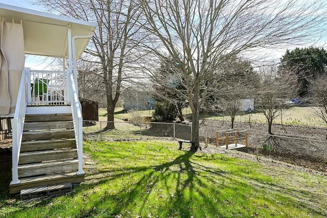 view of yard featuring stairs and fence