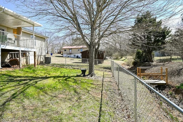 view of yard featuring fence and central AC unit