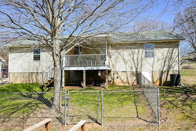 rear view of property with crawl space, stairway, fence private yard, and a gate