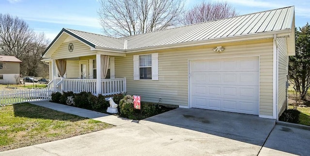 ranch-style house with a standing seam roof, metal roof, a porch, and concrete driveway