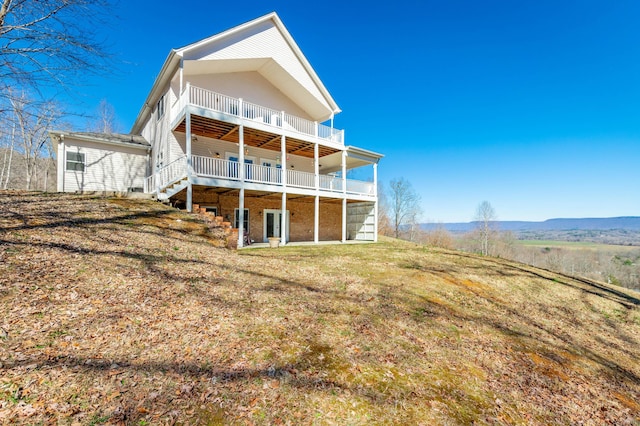 rear view of house featuring a lawn