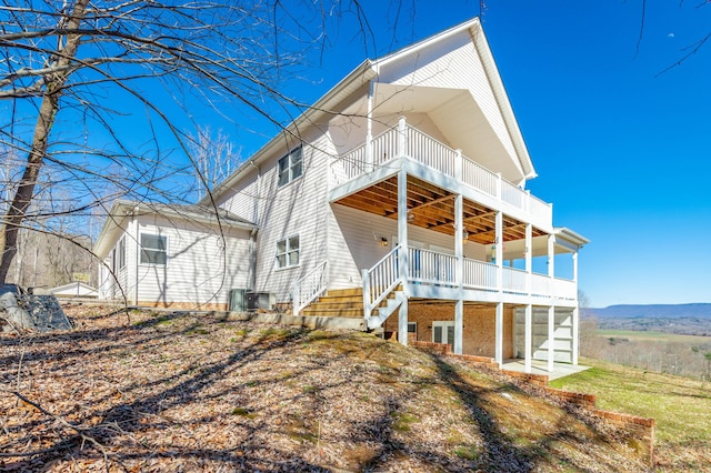 view of front of home with stairway and a deck