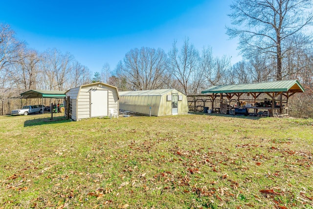 view of yard with an outbuilding, a detached carport, and a shed