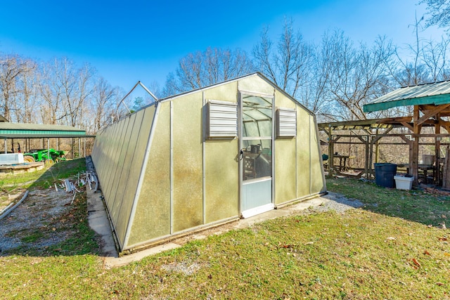 view of greenhouse with a lawn