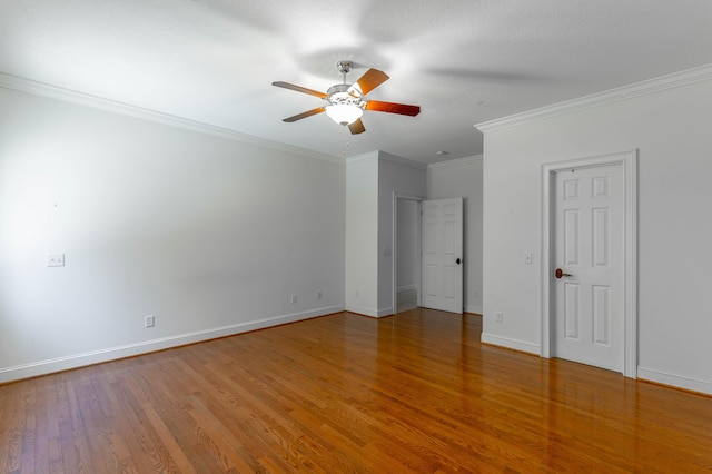 unfurnished bedroom featuring ceiling fan, baseboards, wood finished floors, and ornamental molding