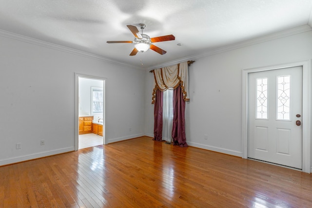 interior space with crown molding, plenty of natural light, and light wood finished floors