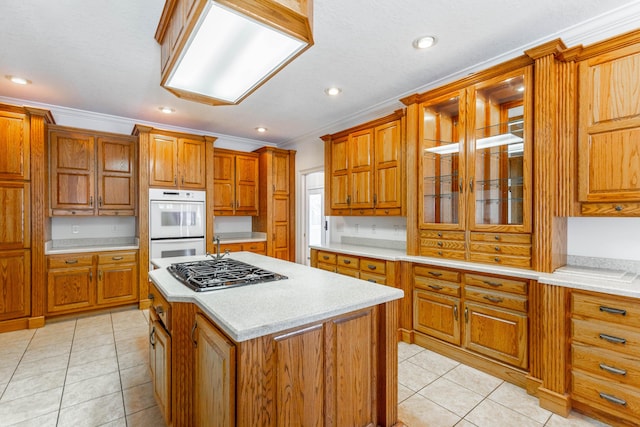 kitchen with brown cabinetry, double oven, and light countertops