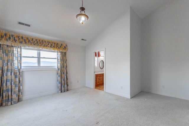 unfurnished bedroom featuring visible vents, light carpet, connected bathroom, high vaulted ceiling, and baseboards