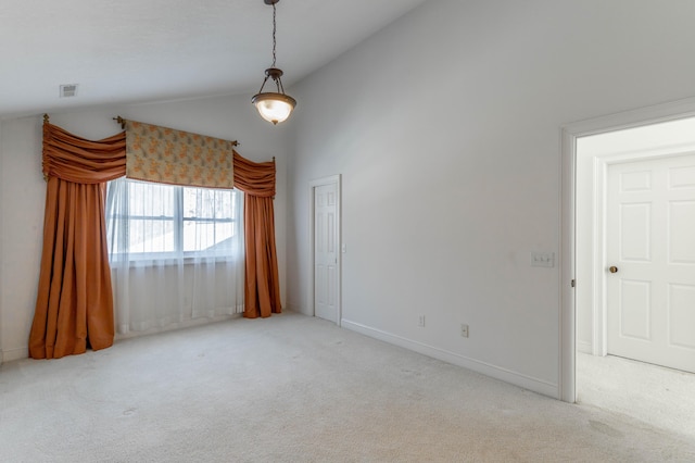 carpeted spare room with high vaulted ceiling, baseboards, and visible vents