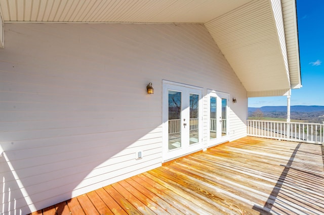 deck with french doors and a mountain view