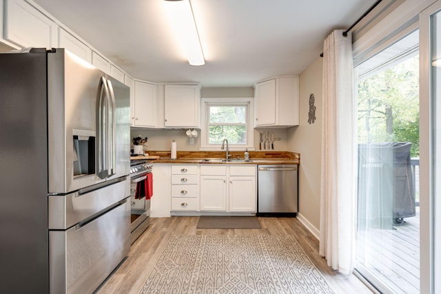 kitchen featuring a sink, white cabinets, and stainless steel appliances