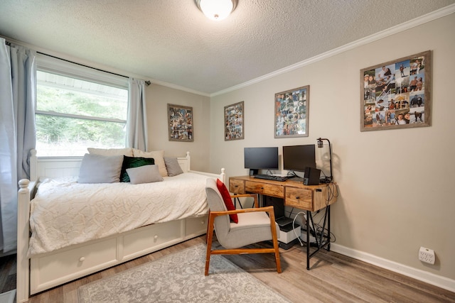 bedroom with wood finished floors, baseboards, and ornamental molding