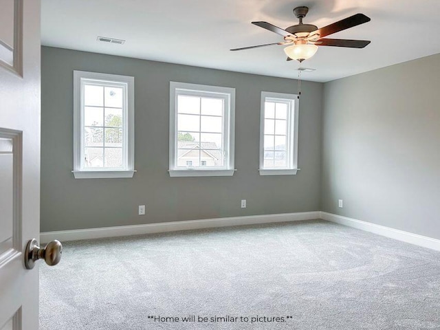 unfurnished room featuring baseboards, visible vents, ceiling fan, and carpet flooring