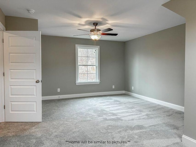 spare room with carpet, baseboards, and ceiling fan