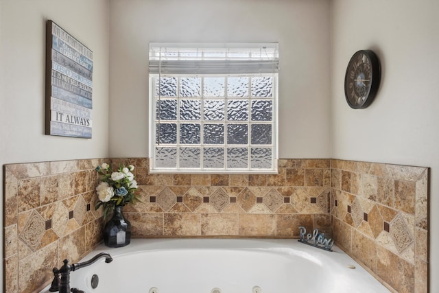 full bath with plenty of natural light and a tub with jets