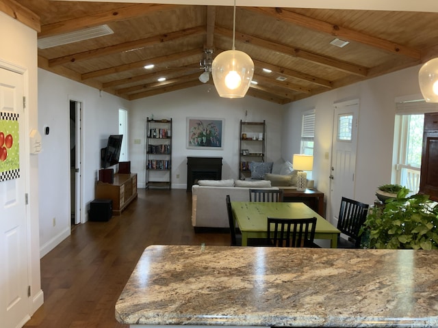 dining room featuring lofted ceiling with beams, dark wood-type flooring, wooden ceiling, and a fireplace