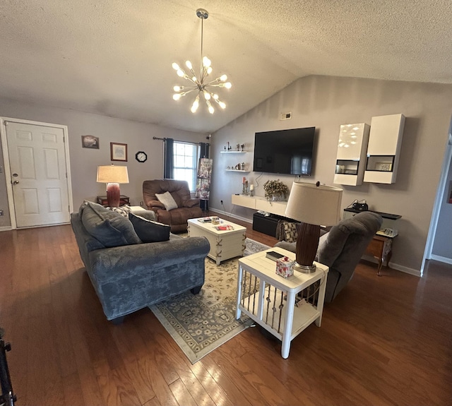 living room with wood finished floors, baseboards, lofted ceiling, a textured ceiling, and a chandelier