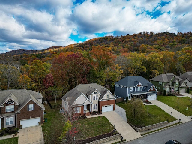 birds eye view of property featuring a view of trees and a residential view