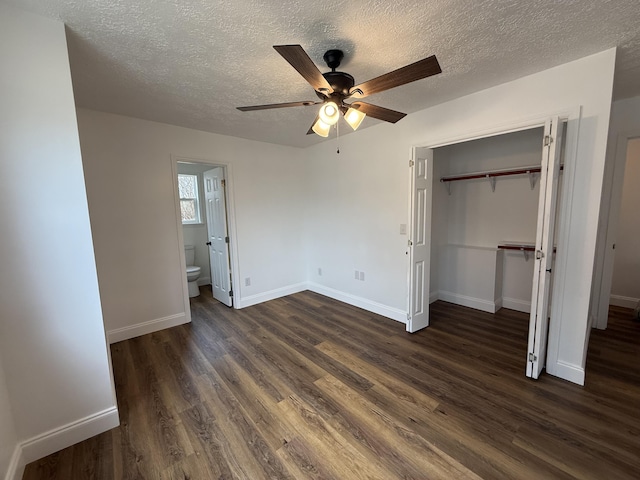 unfurnished bedroom featuring baseboards, dark wood finished floors, ceiling fan, a textured ceiling, and a closet