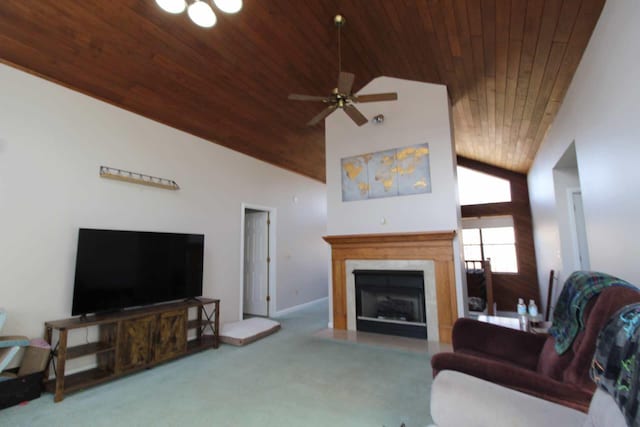 living area featuring ceiling fan, high vaulted ceiling, a fireplace with flush hearth, wood ceiling, and carpet