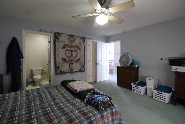 bedroom featuring ceiling fan, carpet floors, and ensuite bath