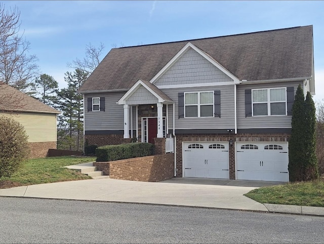 split foyer home featuring concrete driveway, brick siding, a garage, and roof with shingles