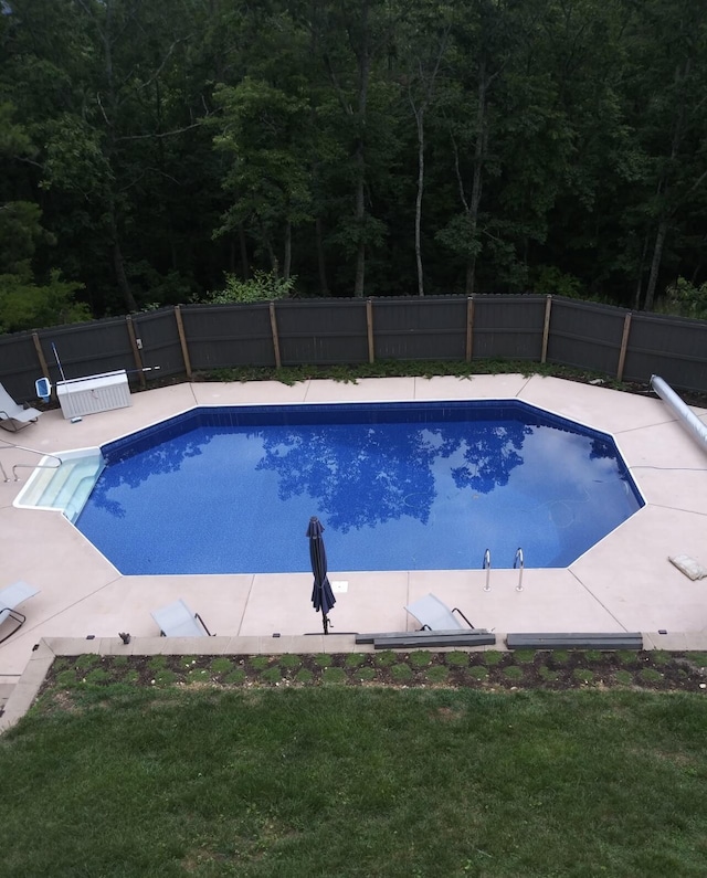 view of pool featuring a fenced in pool, a lawn, a fenced backyard, and a patio area