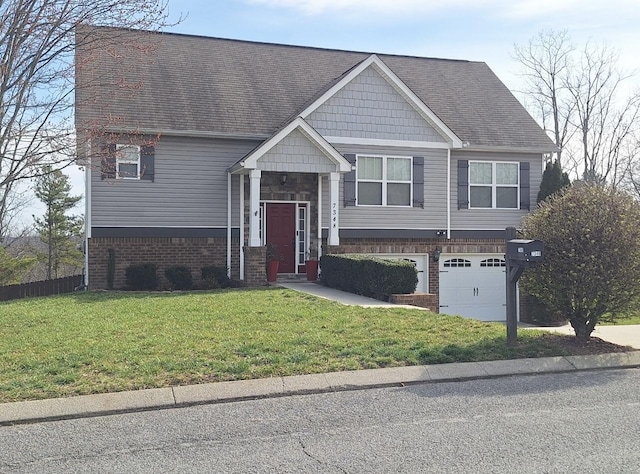 split foyer home featuring brick siding, a garage, a shingled roof, and a front yard