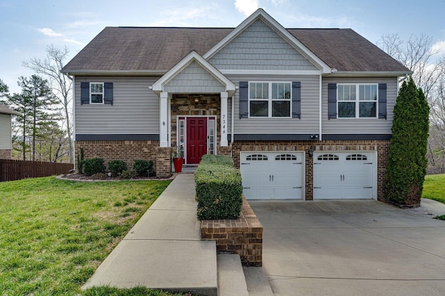 split foyer home with brick siding, a front lawn, fence, concrete driveway, and an attached garage